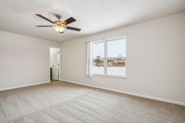 empty room featuring carpet floors and ceiling fan