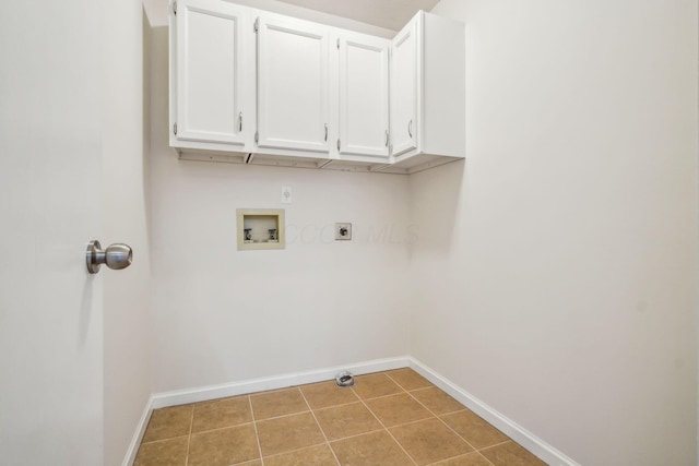 clothes washing area featuring light tile patterned flooring, gas dryer hookup, cabinets, hookup for a washing machine, and hookup for an electric dryer