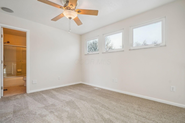 carpeted empty room featuring ceiling fan