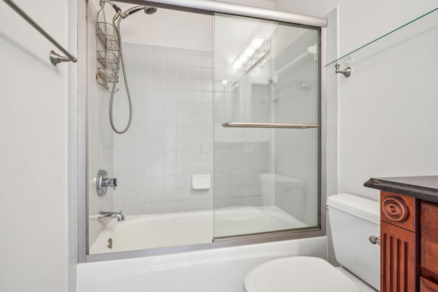 bathroom with toilet and combined bath / shower with glass door