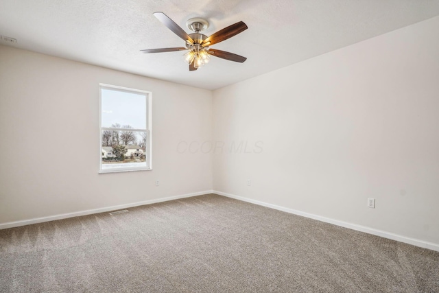 carpeted empty room featuring ceiling fan