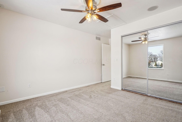 unfurnished bedroom featuring carpet, ceiling fan, and a closet