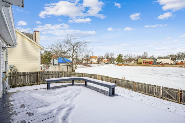 yard layered in snow with a deck