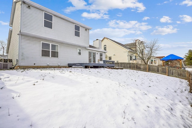 snow covered house featuring a deck and central air condition unit