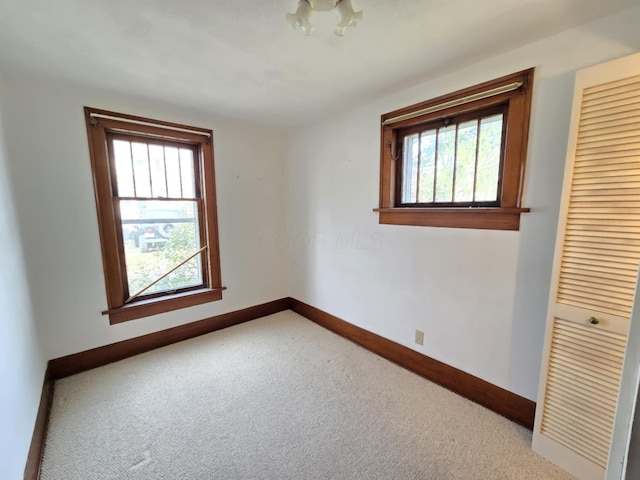 215 S Jefferson St, Galion, OH 44833 - carpeted empty room featuring baseboards