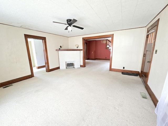 215 S Jefferson St, Galion, OH 44833 - unfurnished living room with visible vents, a ceiling fan, carpet flooring, and a fireplace