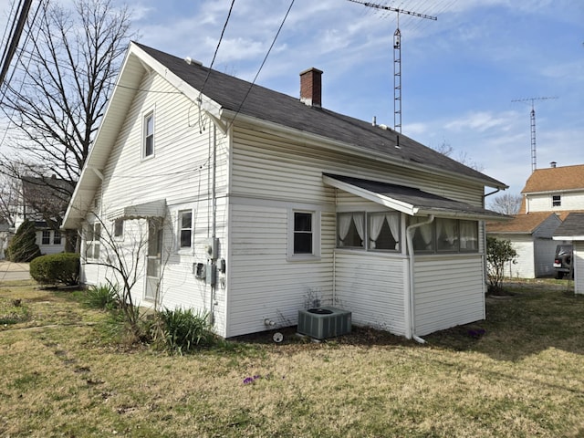 215 S Jefferson St, Galion, OH 44833 - rear view of property with a lawn, central AC unit, and a chimney
