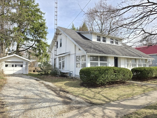 215 S Jefferson St, Galion, OH 44833 - view of front facade featuring a garage, roof with shingles, an outdoor structure, and driveway