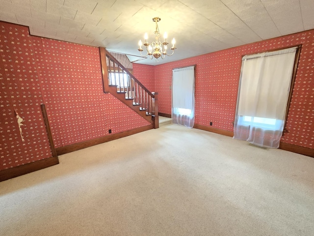 215 S Jefferson St, Galion, OH 44833 - unfurnished living room featuring wallpapered walls, baseboards, stairs, carpet flooring, and an inviting chandelier