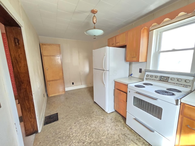 215 S Jefferson St, Galion, OH 44833 - kitchen with white appliances, light floors, visible vents, hanging light fixtures, and light countertops