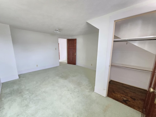 215 S Jefferson St, Galion, OH 44833 - unfurnished bedroom featuring a closet, baseboards, and carpet floors