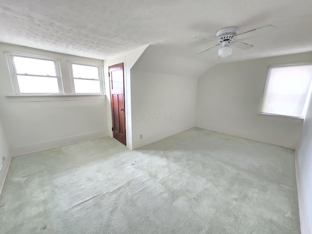 215 S Jefferson St, Galion, OH 44833 - additional living space with carpet, lofted ceiling, a ceiling fan, and a textured ceiling