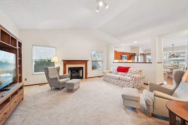 carpeted living room with lofted ceiling and a tiled fireplace