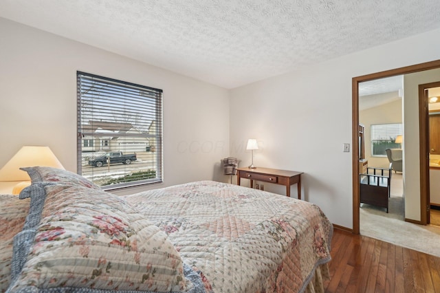 bedroom featuring dark hardwood / wood-style floors and a textured ceiling