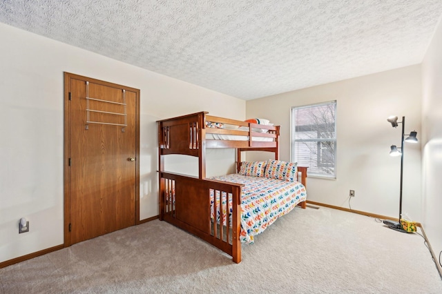 bedroom with light colored carpet and a textured ceiling