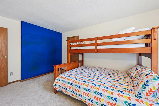 bedroom featuring light carpet and a textured ceiling