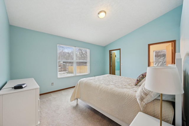 bedroom featuring light colored carpet and vaulted ceiling