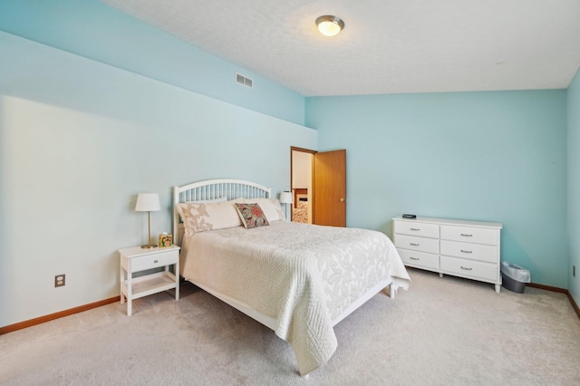 carpeted bedroom featuring a textured ceiling