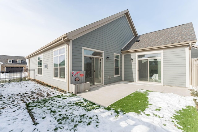 snow covered property with a patio area