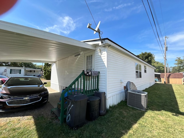 view of property exterior featuring central AC, a carport, and a lawn