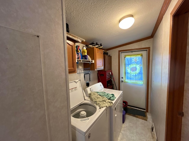 clothes washing area with crown molding, cabinets, washer and clothes dryer, and a textured ceiling