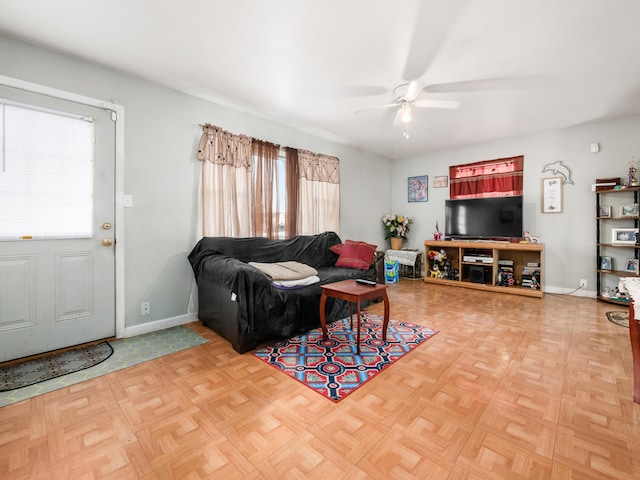 living room with ceiling fan and parquet flooring