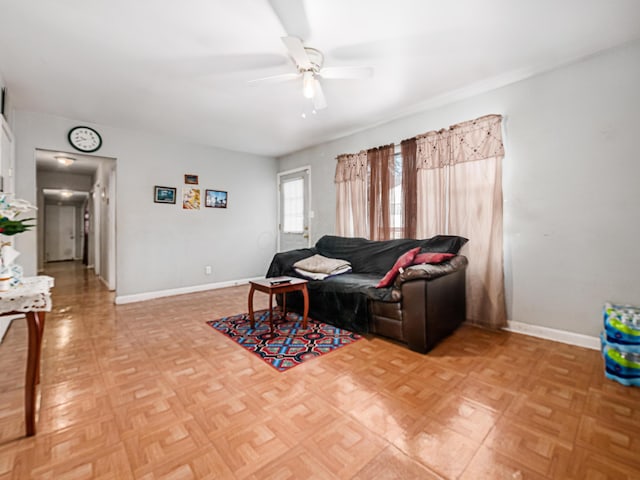 living room featuring ceiling fan and light parquet flooring