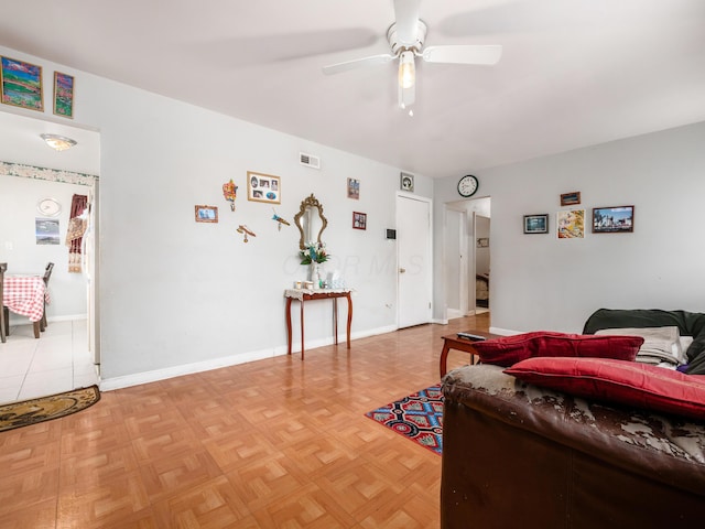 living room with ceiling fan and parquet flooring