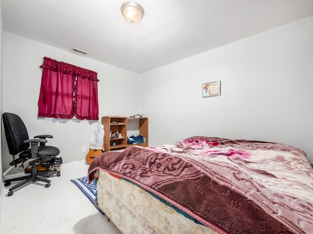 bedroom featuring concrete flooring