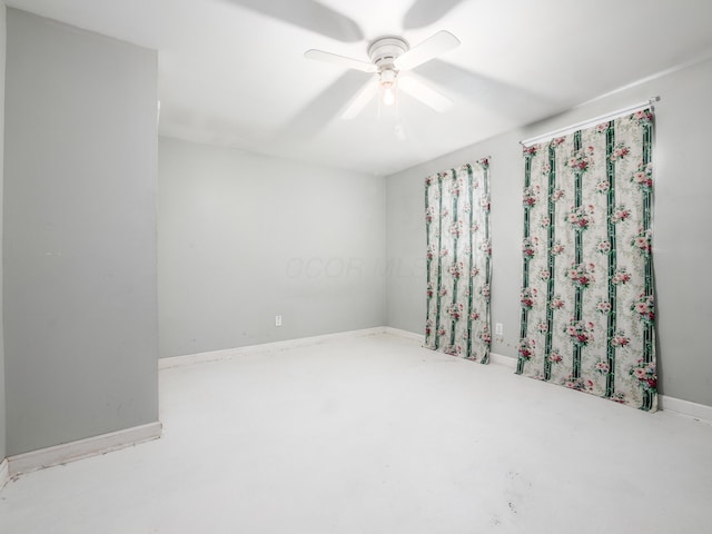 empty room with concrete floors and ceiling fan