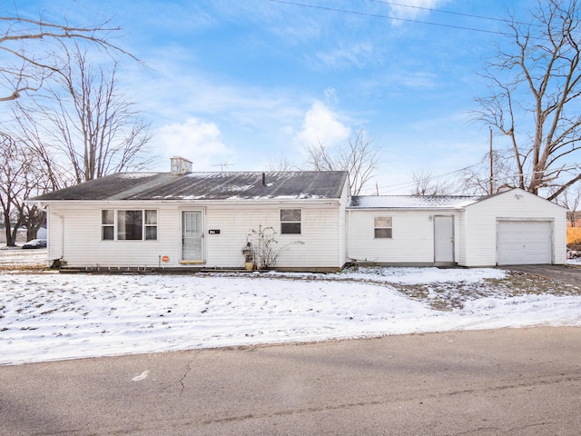 single story home with a garage and an outbuilding