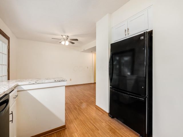 kitchen featuring white cabinetry, stainless steel dishwasher, light wood-type flooring, black fridge, and ceiling fan