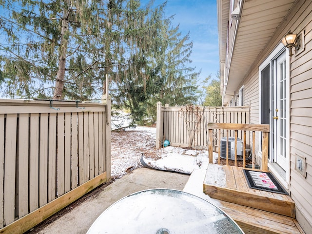 snow covered patio with central AC