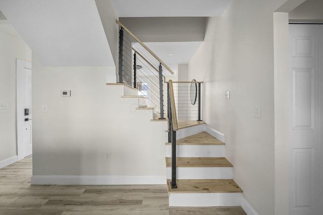 stairs with hardwood / wood-style flooring