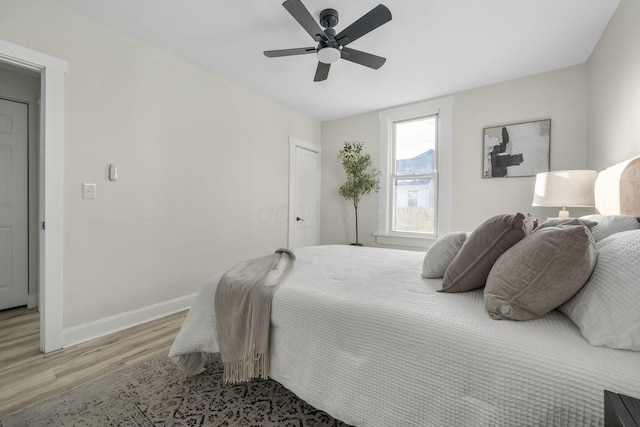 bedroom with ceiling fan and light hardwood / wood-style floors