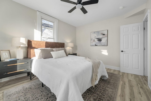 bedroom with ceiling fan and light wood-type flooring