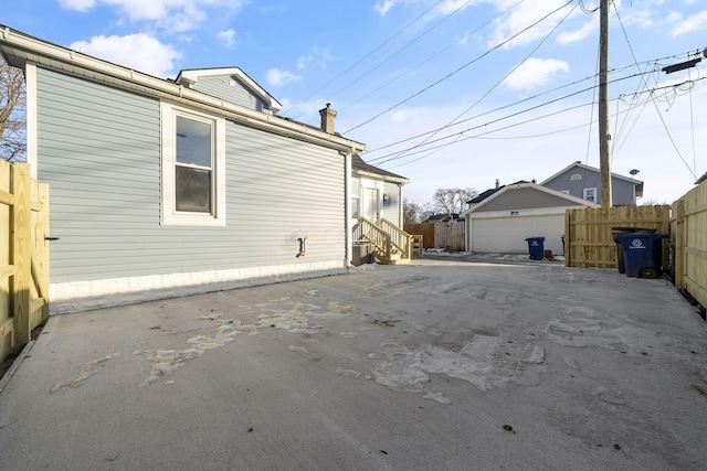 view of side of property featuring an outbuilding and a garage