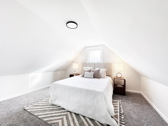 carpeted bedroom with lofted ceiling