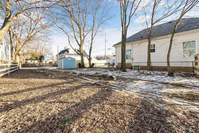 snowy yard with a shed