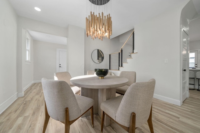 dining room featuring a chandelier and light hardwood / wood-style flooring