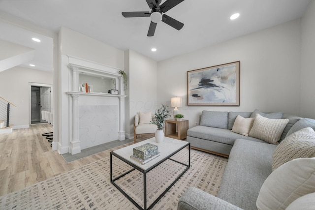 living room featuring light hardwood / wood-style floors and ceiling fan