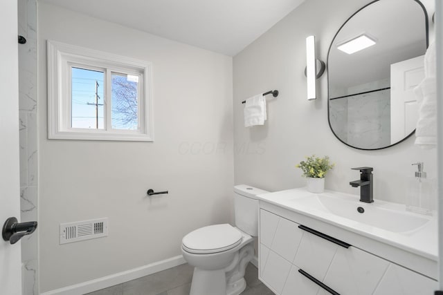 bathroom featuring tile patterned flooring, vanity, and toilet