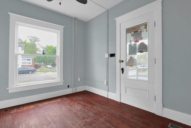 doorway featuring ceiling fan and dark wood-type flooring