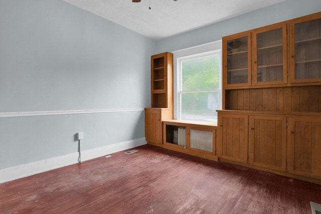 empty room featuring ceiling fan and dark hardwood / wood-style floors