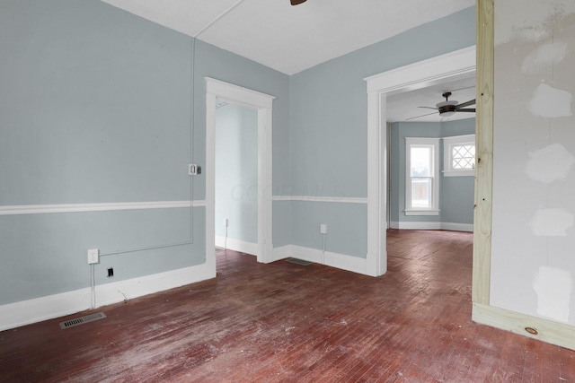 unfurnished room with ceiling fan and dark wood-type flooring