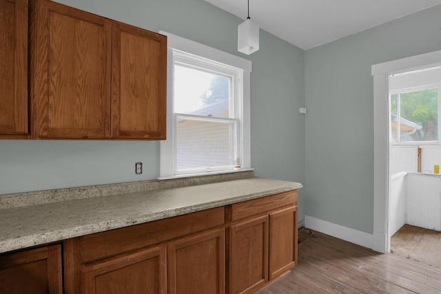 kitchen featuring light stone countertops and pendant lighting