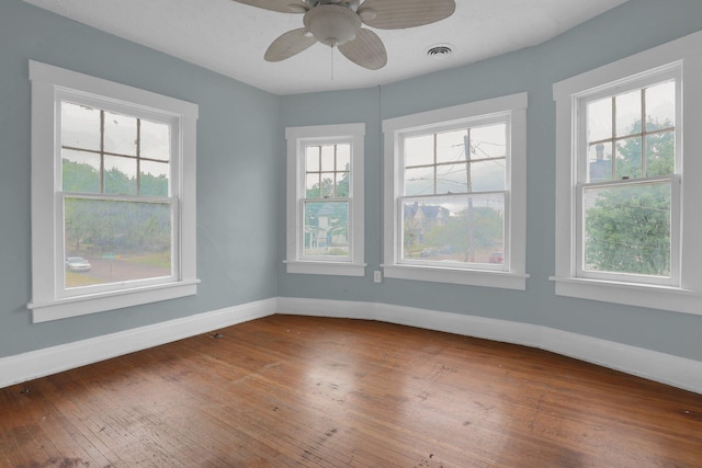 empty room with ceiling fan and wood-type flooring