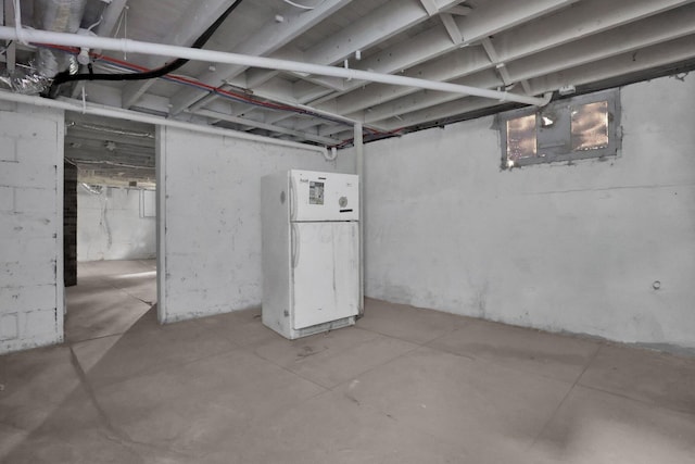 basement featuring white refrigerator