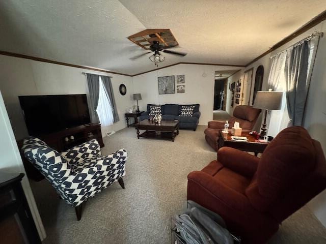 living room featuring crown molding, ceiling fan, carpet flooring, a textured ceiling, and lofted ceiling