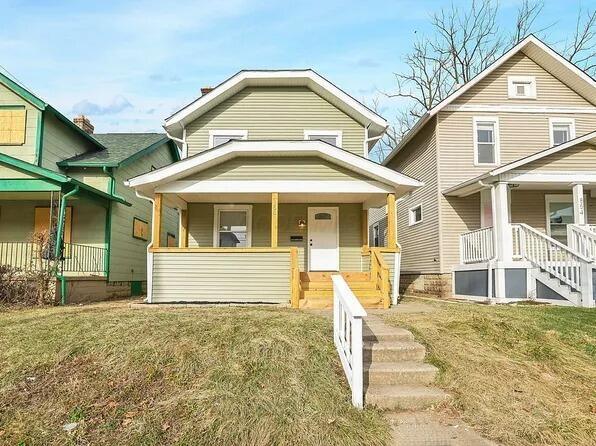 view of front of house with a front yard and a porch